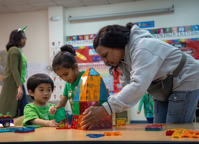 An image of students working with a teacher at the ECE Center.